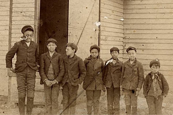 historic photo of boys standing in front of school