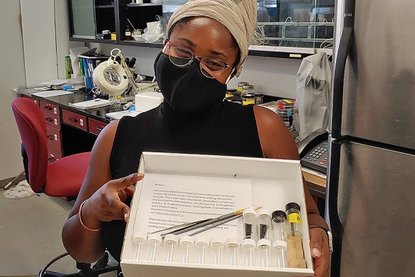 Patricia Okpara holding insect collection kit