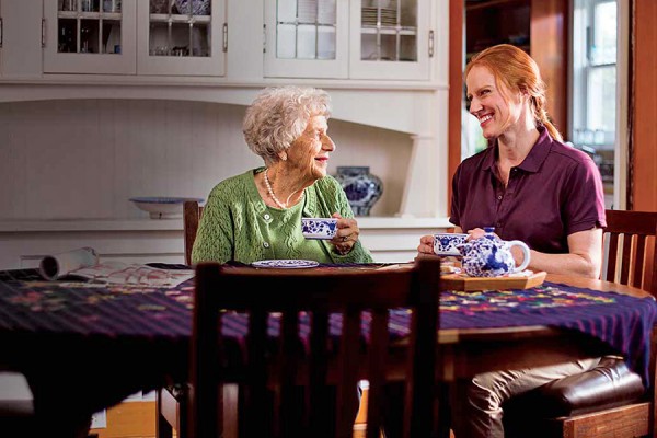 elder and young woman sharing tea