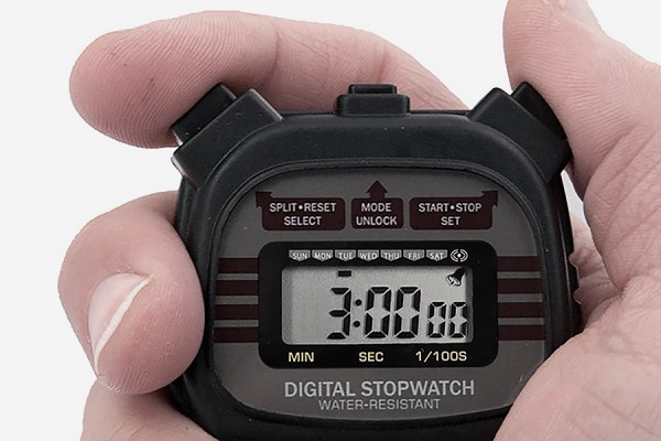 hand holding stopwatch marking 3 minutes