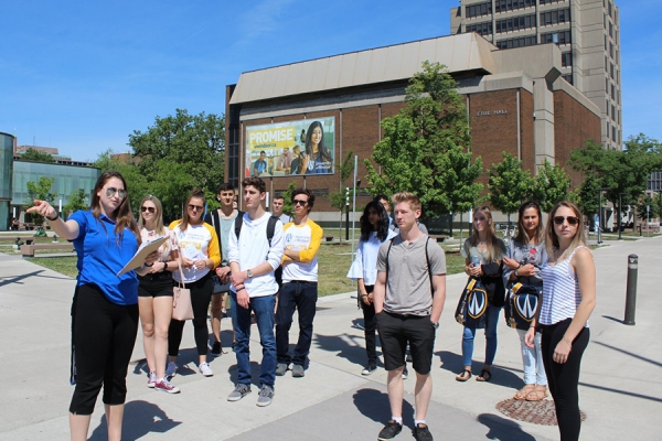 student leading campus tour