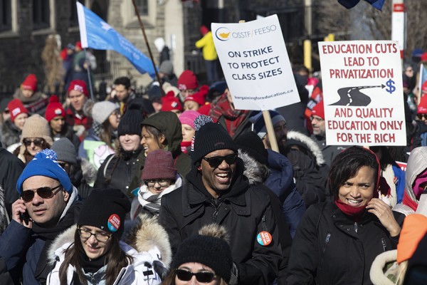 Protesters join a demonstration organized by teachers’ unions outside the Ontario legislature on Feb. 21.