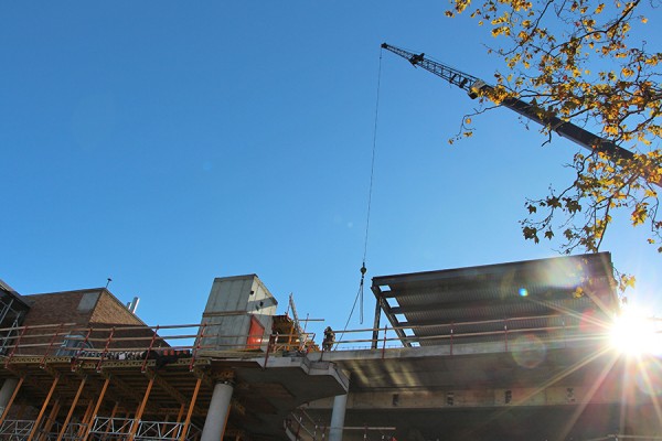 crane lifting material to top of science building under construction