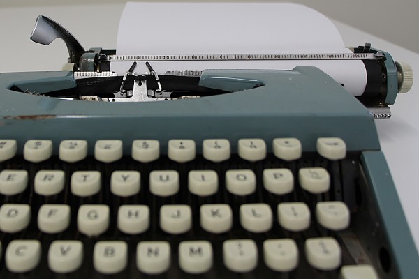 typewriter with blank paper inserted