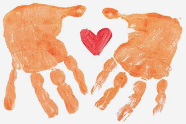 prints of hands surrounding heart