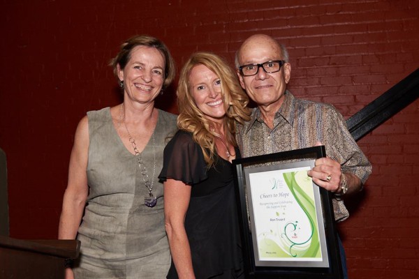 Lisa Porter (m.), Windsor Cancer Research Translational Research Director and Caroline Hamm (l.), WCRG Clinical Director present an award to Ron Truant, WCRG Executive Committee member, during WCRG’s Cheers to Hope event. Photo courtesy of Snapd.