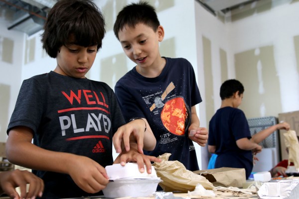 Lancer Engineering campers put the finishing touches on their apparatus that will carry their egg from the third floor of the Ed Lumley Centre for Engineering Innovation to the ground.