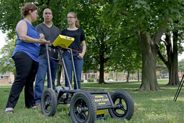 Earth and Environmental Sciences Professor Maria Cioppa, History professor Guillaume Teasdale and high school student Grace Dycha examine the readings on the Noggin ground penetrating radar.  