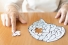 elderly hands piecing together jigsaw puzzle of brain