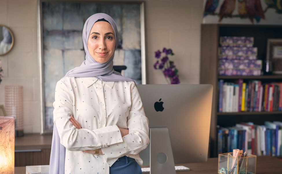 Female student teacher standing at her desk