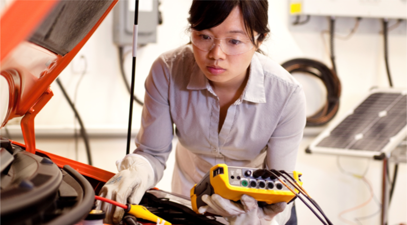 A student conducts tests on a vehicle.