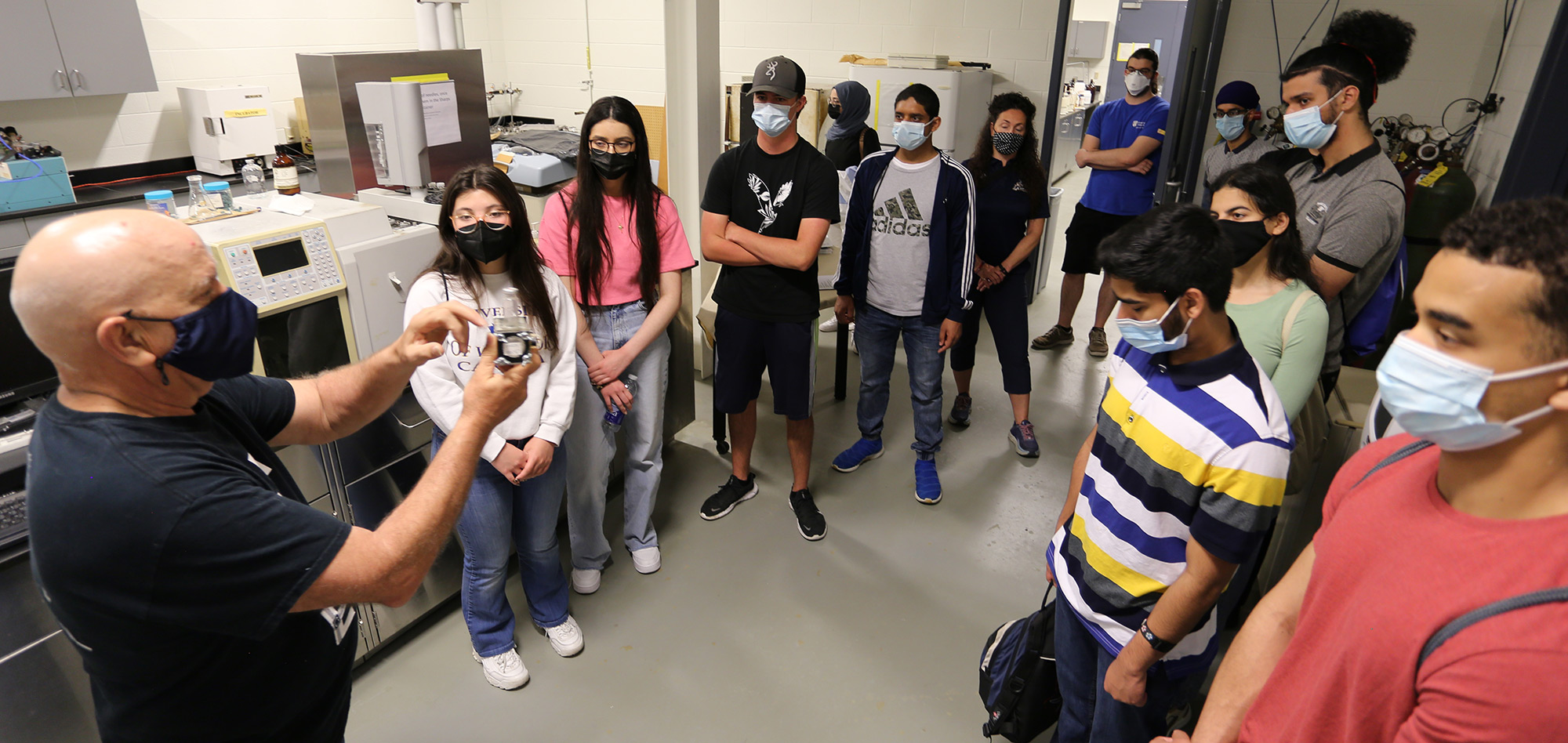 Bill Middleton, an environmental technologist in civil and environmental engineering, explains a biofuel cell to a group of prospective students in the Environmental Lab