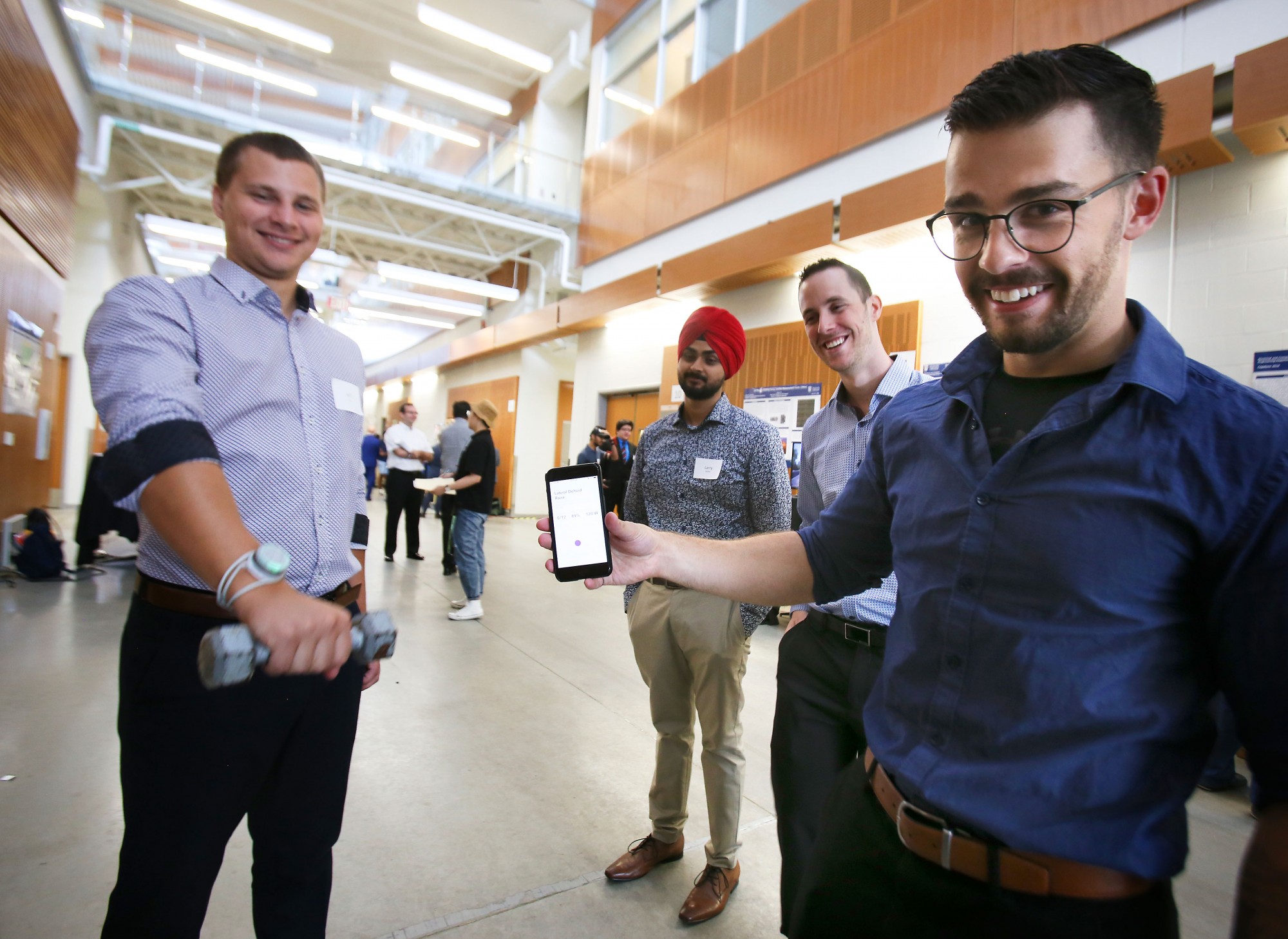 Jeff Bilek, Larry Sandhu, Aaron Marson and Connor Holowachuk display their fitness-based wearable