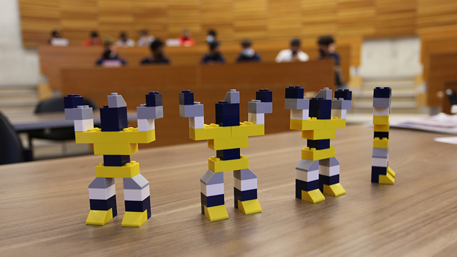 Robots made out of Lego lined up on a table