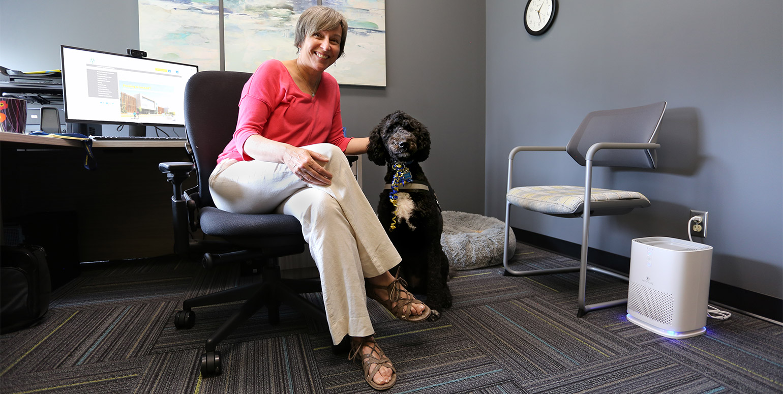 Clinical therapist Giselle St. Louis and Winnie the therapy dog