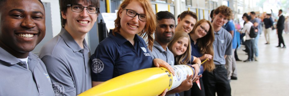 Students hold a rocket