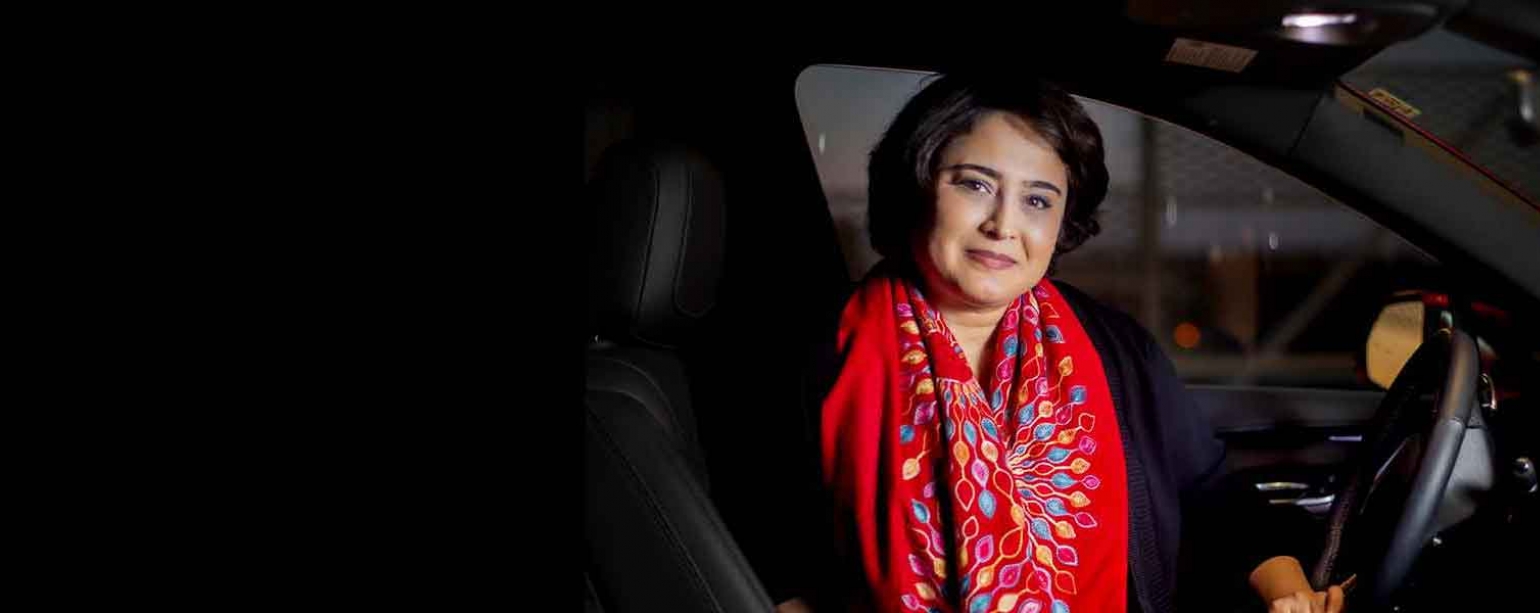 Mitra Mirhassani sits in a vehicle