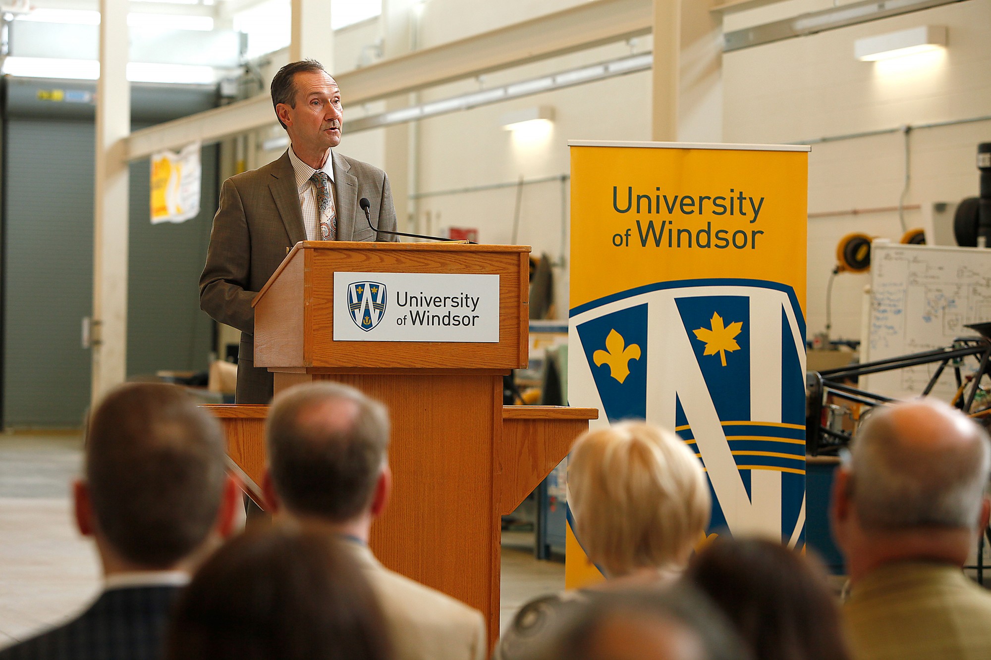 Keith Henry (R), president and CEO of the Windsor Mold Group giving speech.