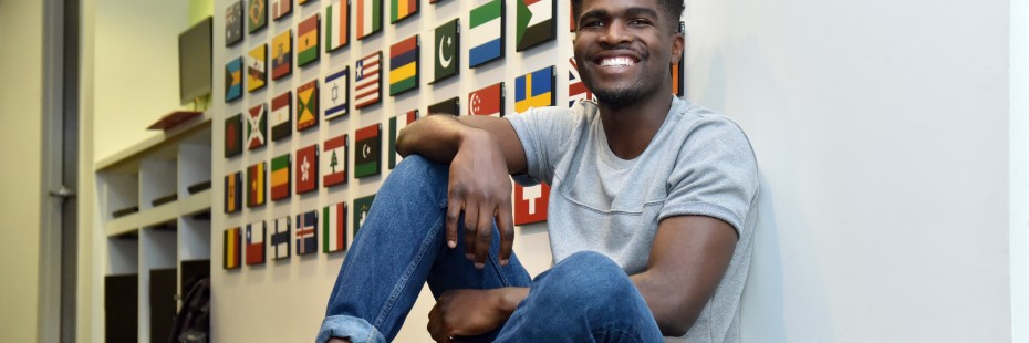 Student in front of International Flag Board