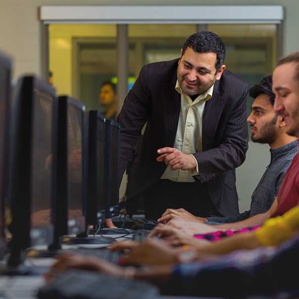 Professor with students in computer lab