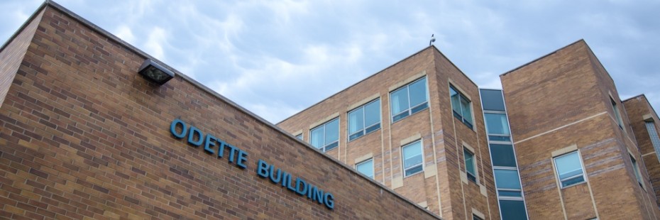Photo of the Odette Building, UWindsor Campus, against a blue sky