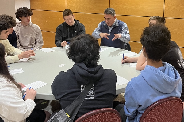 Professor Marcello Guarini leads consideration of philosophical questions during a salon for high school students.