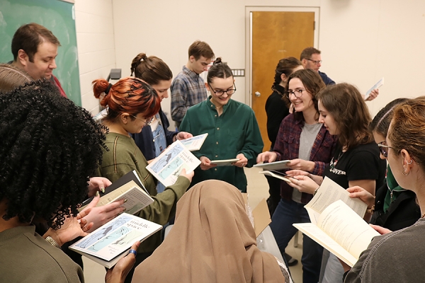 Students unbox copies of the anthology they produced in the Editing and Publishing Practicum course. A public event April 6 will formally launch “In the Middle Space,” which celebrates Windsor’s public art through storytelling.