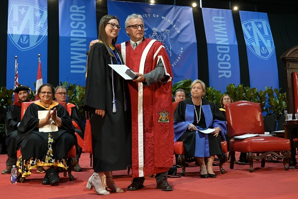 President’s Medallist Mary Desaulniers accepts congratulations from UWindsor president Robert Gordon during Convocation celebrations, May 30 in the Toldo Lancer Centre.