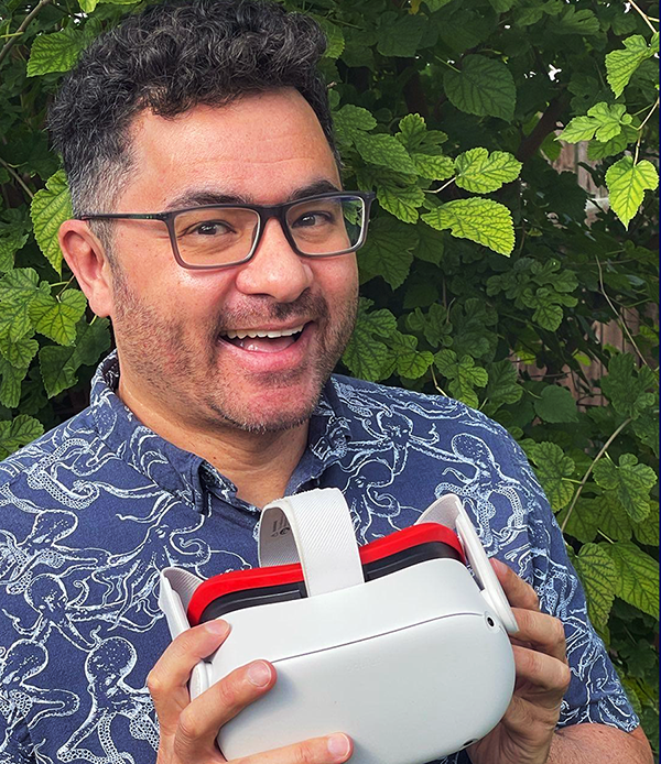 Oliver Balmokune holds a pair of virtual reality goggles