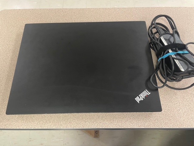 Lenovo black laptop closed with power cable