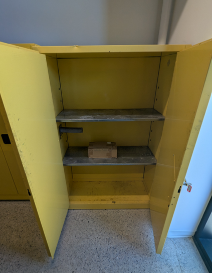 yellow flammables cabinet doors open , 2 shelves