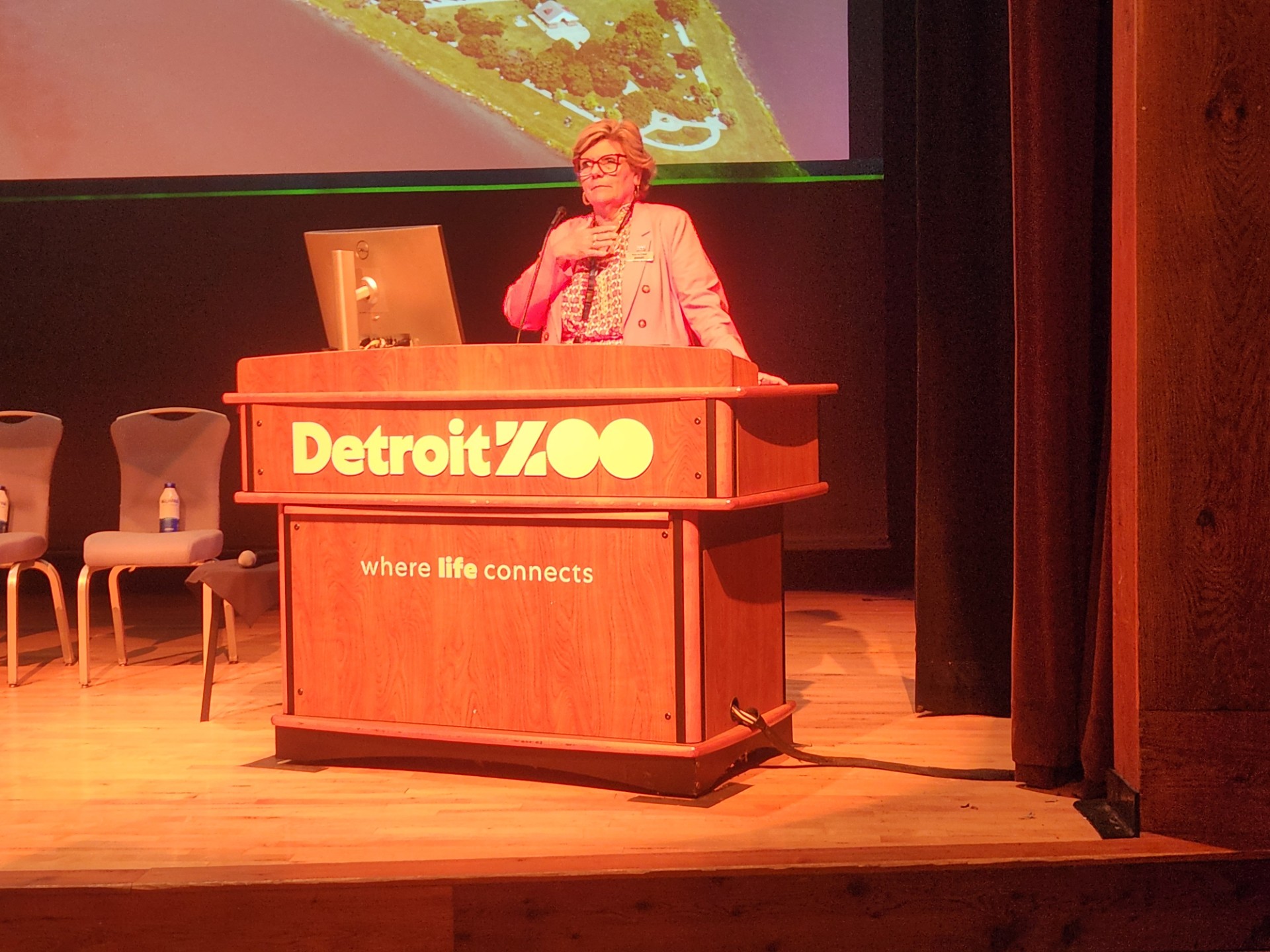 Dr. Haley Murphy opens the State of the State 2026 conference at a podium at the Detroit Zoo