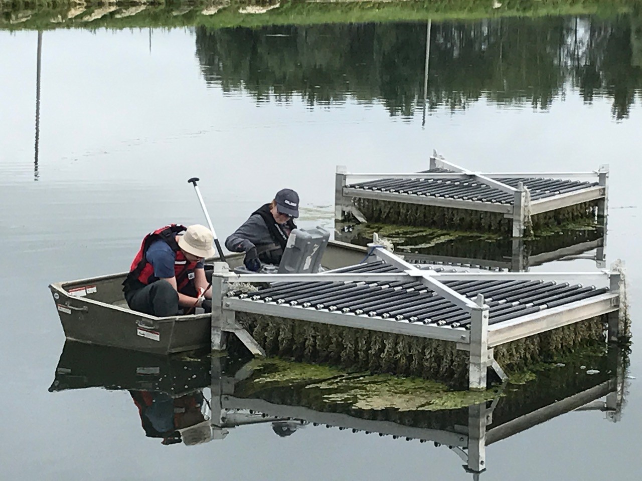 researchers working in a boat near a research platform 