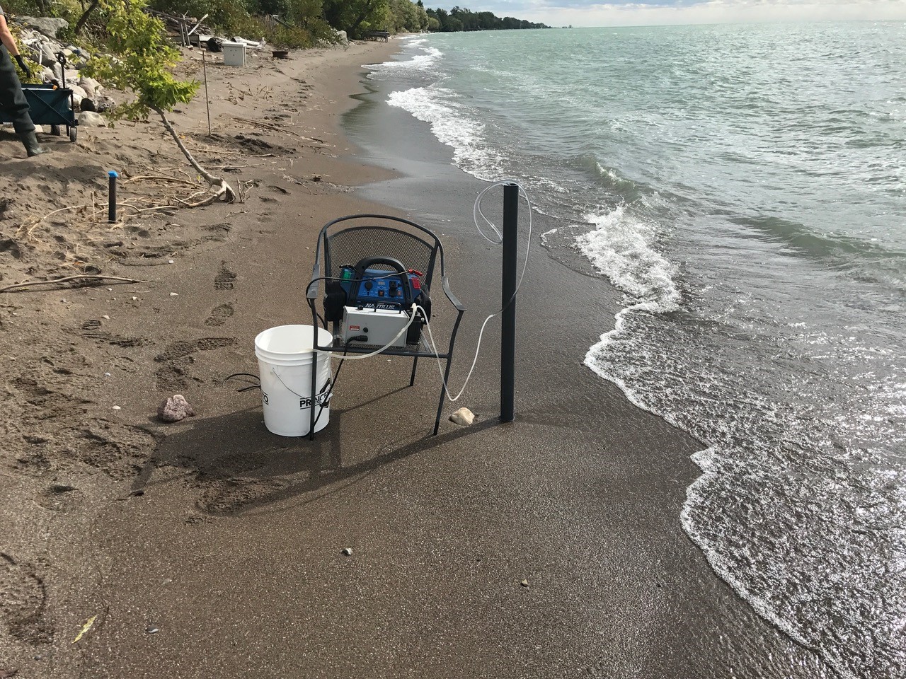 research equipment testing sediment on a beach beside a lake
