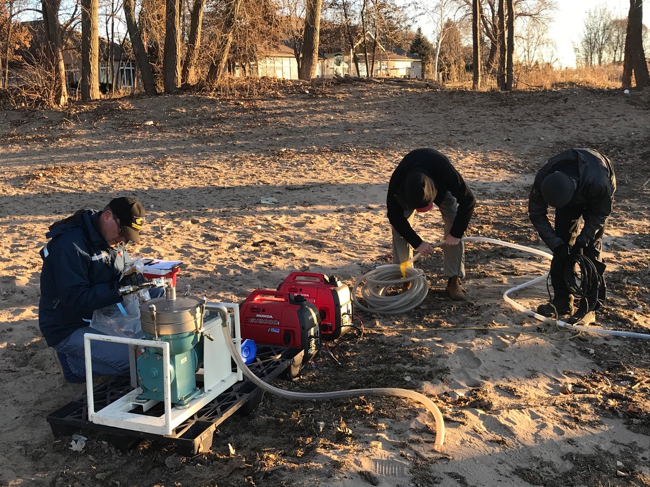 people sampling sand on a beach