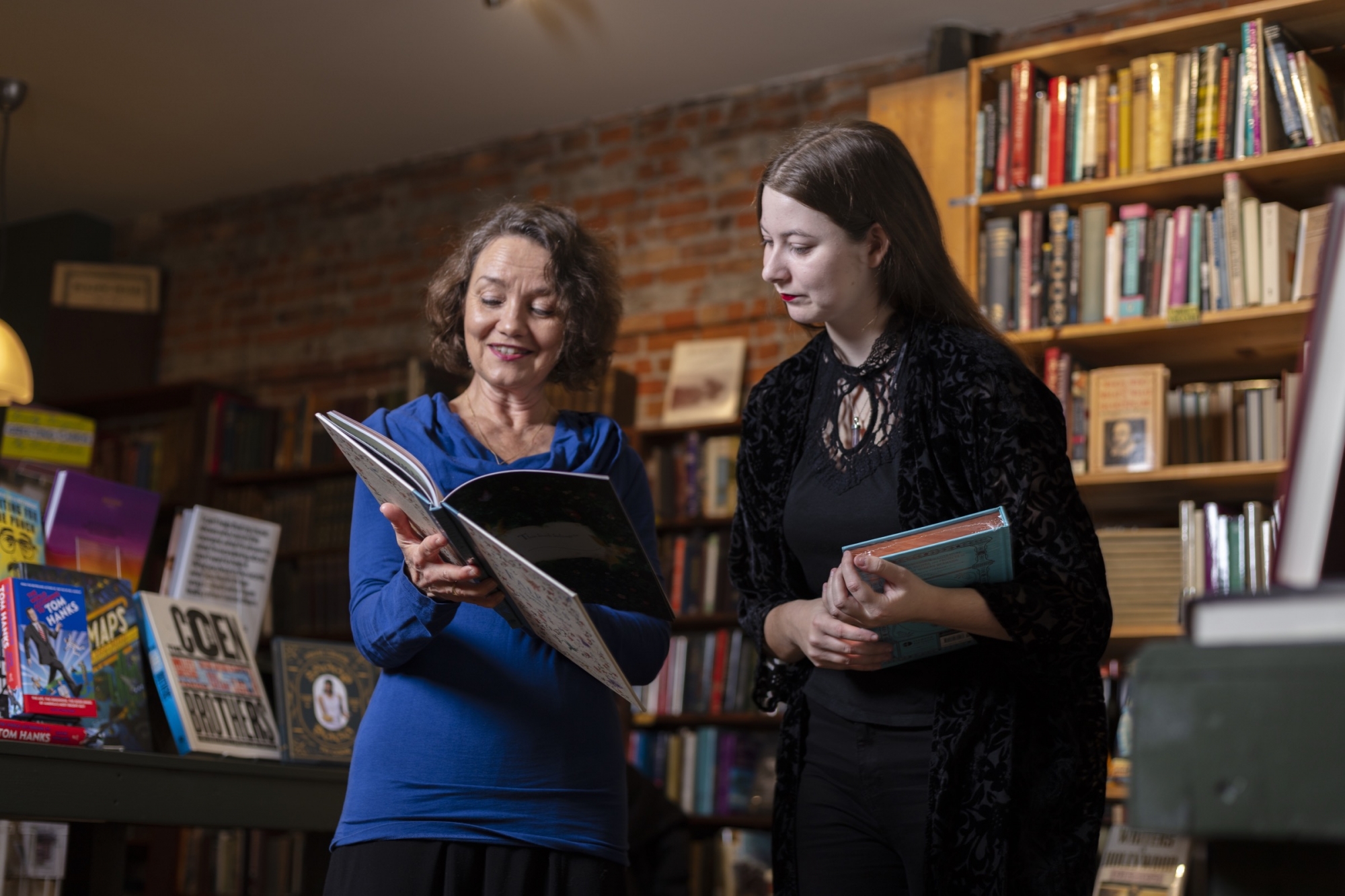 Tutor and student reading a book