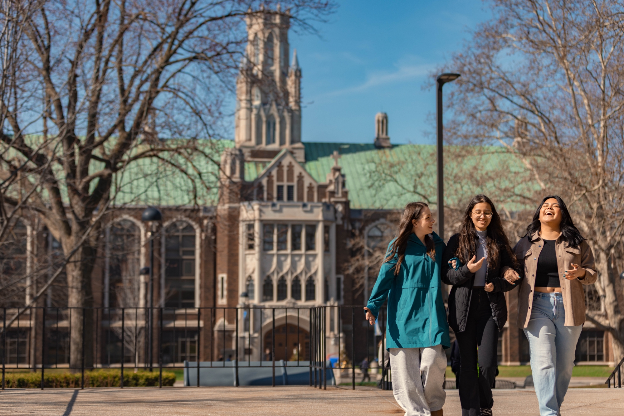 Three students walking in the university