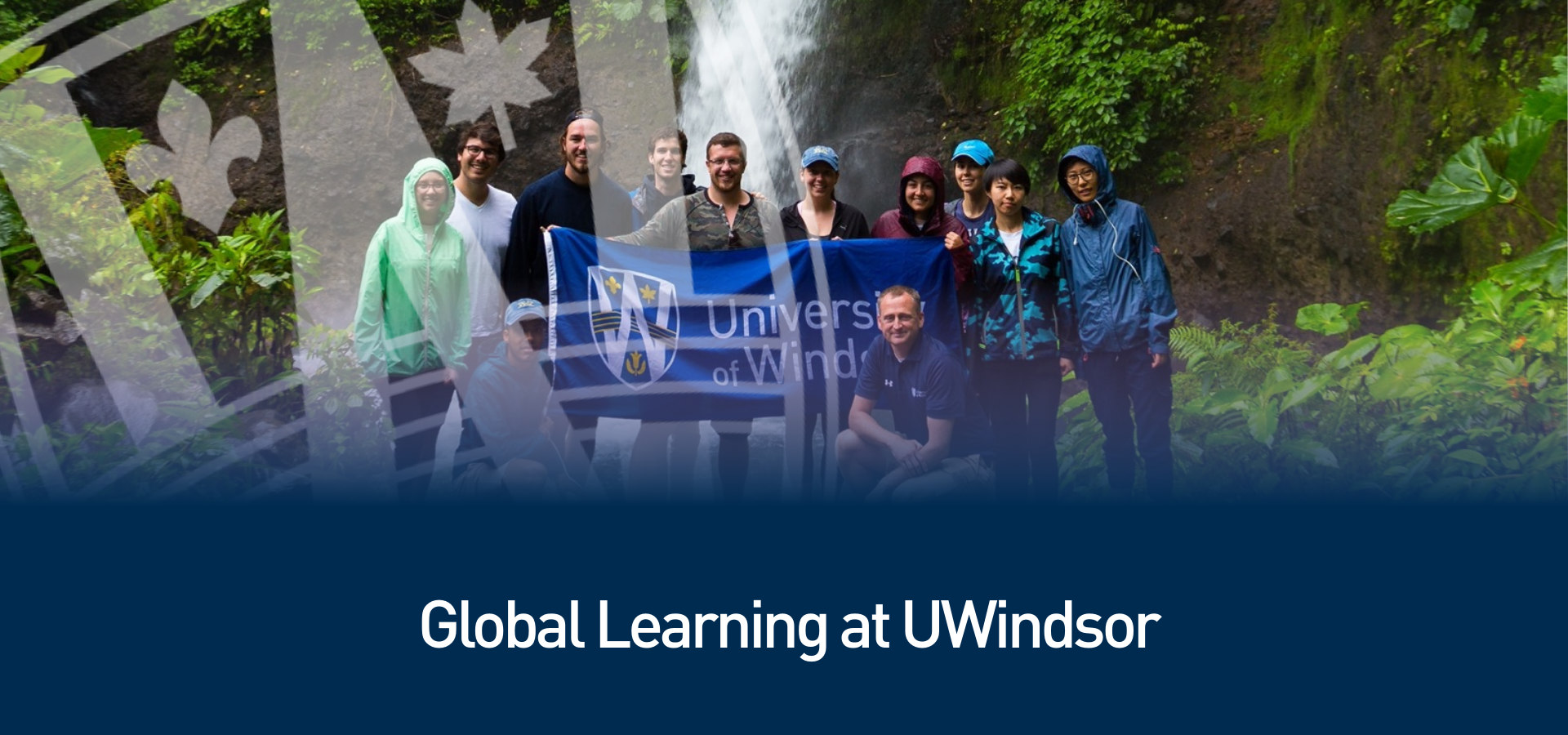 A group of people holding UWindsor banner
