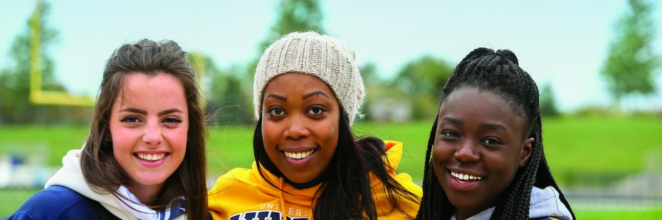 three female students in University of Windsor shirts