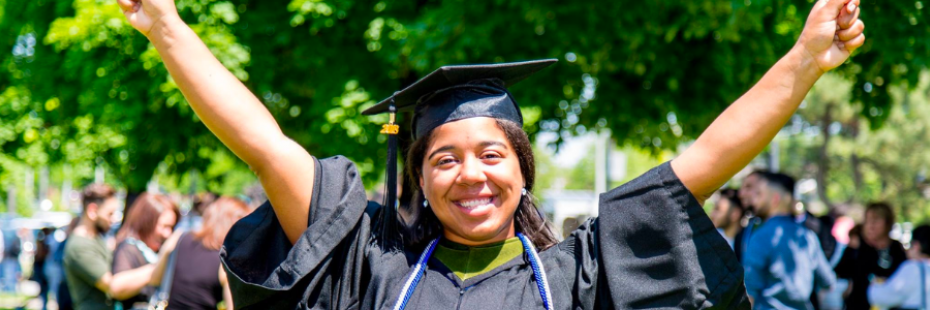 Graduate raises her hands in excitement 