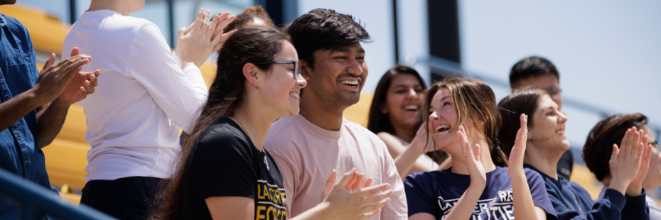 Students cheering at alumni field