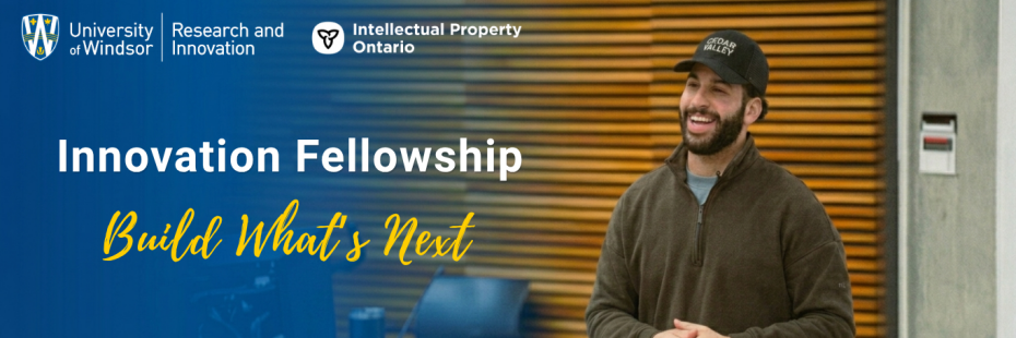 Man standing with his hands together standing in front of classroom. Text that reads "University of Windsor Fellowship Build What's Next"