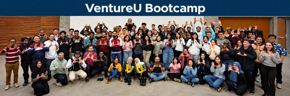 A group of students standing together in front of a classroom with a projector screen titled VentureU