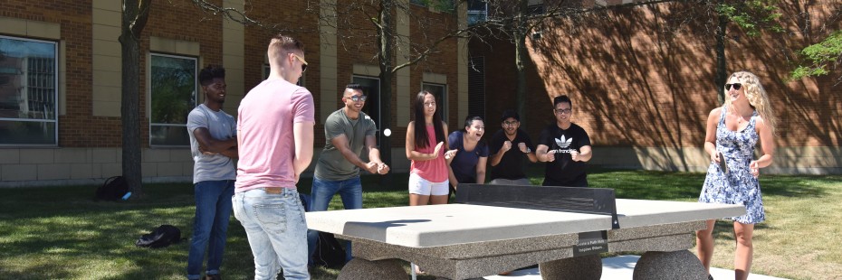 Group of students playing ping-pong in the David A. Wilson Commons on campus