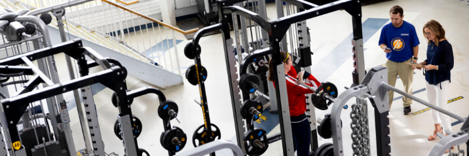 One student squats while two researchers analyze 