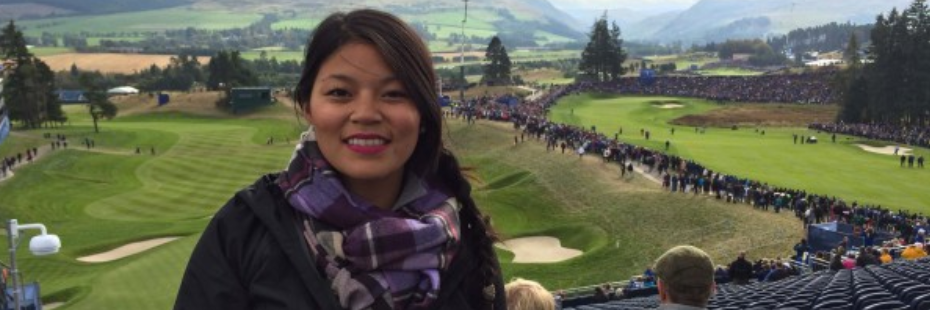 Woman in the stands at a golf course