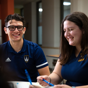 Three students smiling in the lounge