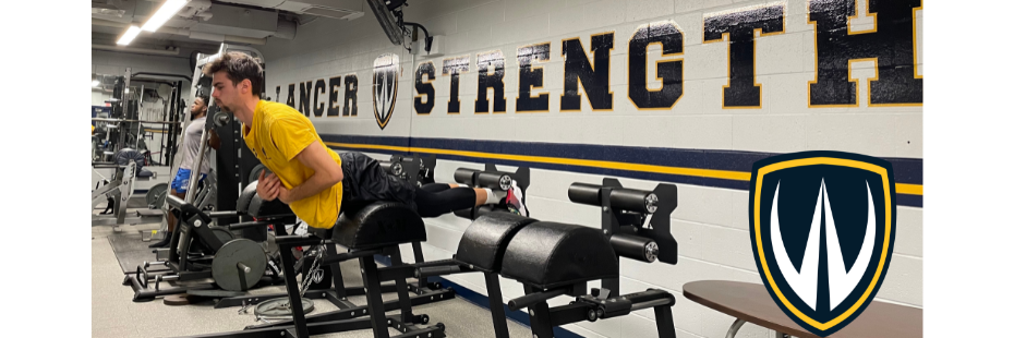 Male students work out in weight room.