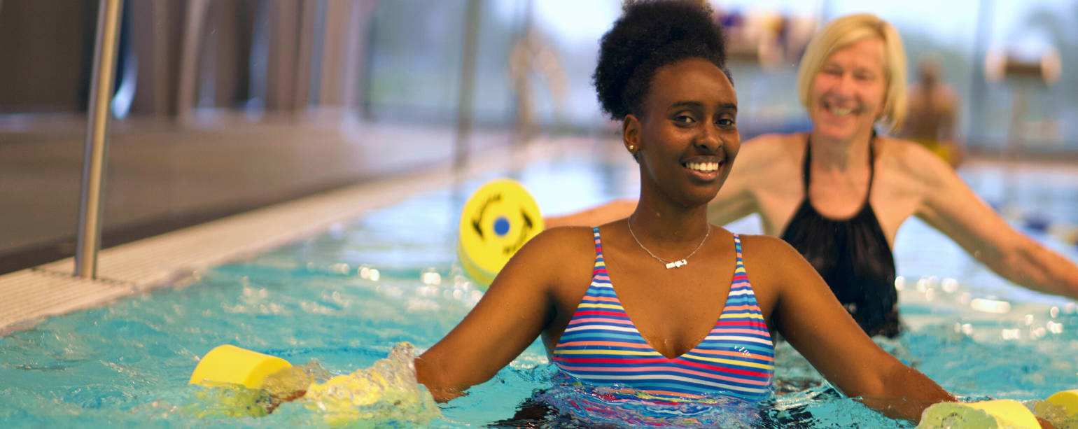 Two women participating in aqua fitness