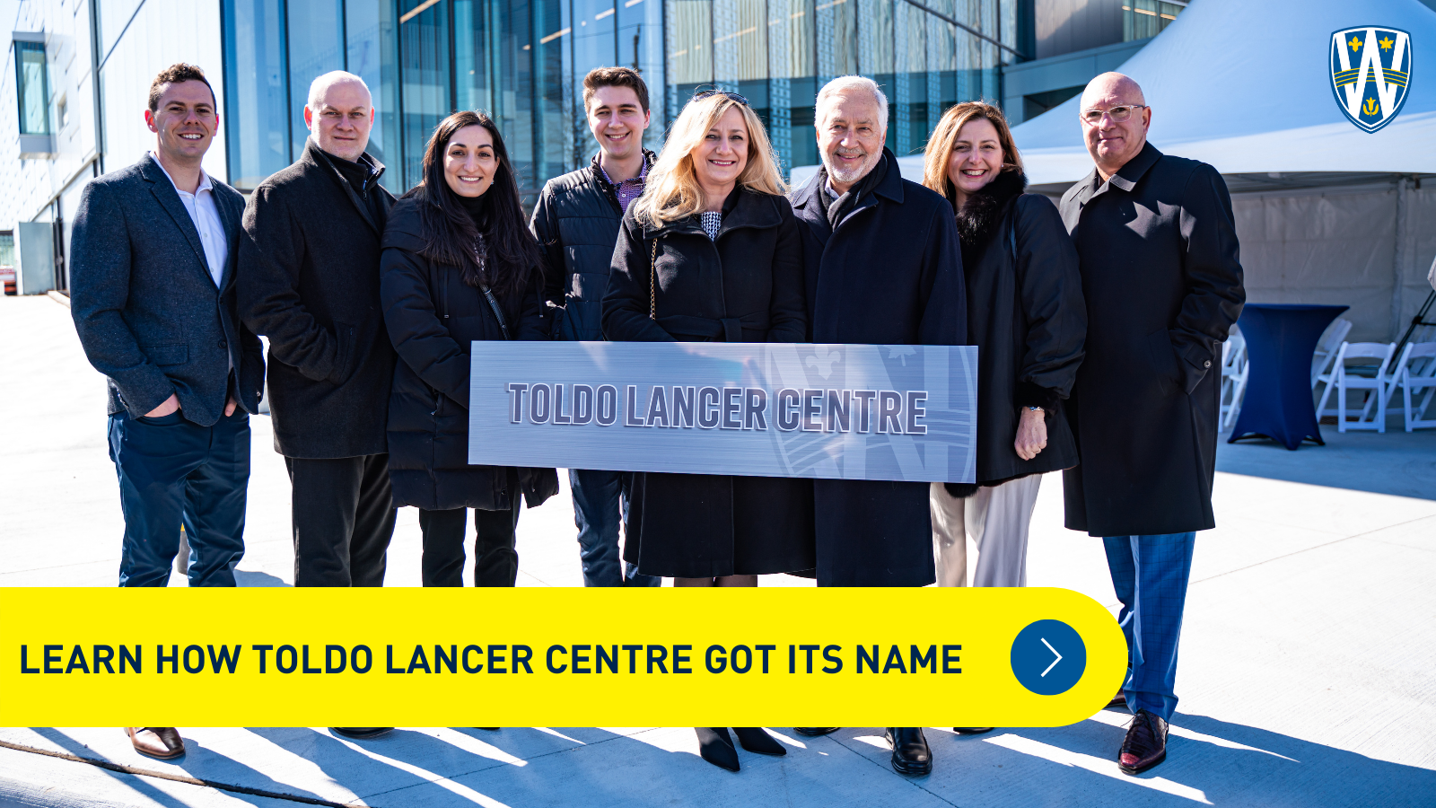 8 individuals from the Toldo Family stand in front of Toldo Lancer Centre 